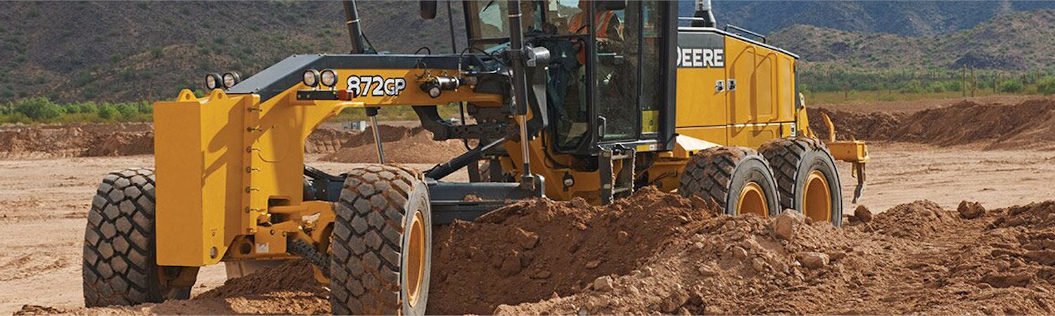 Yellow John Deere® motor grader on a construction site